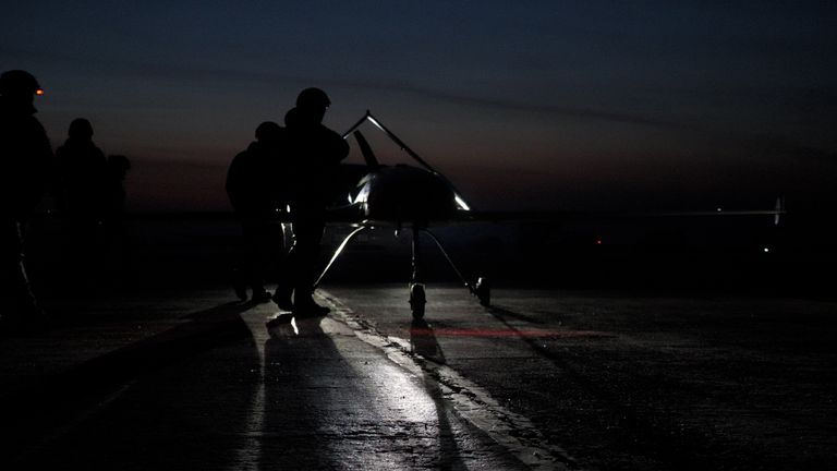 As night falls, members of an elite branch of Ukraine's armed forces prepare a line of drones