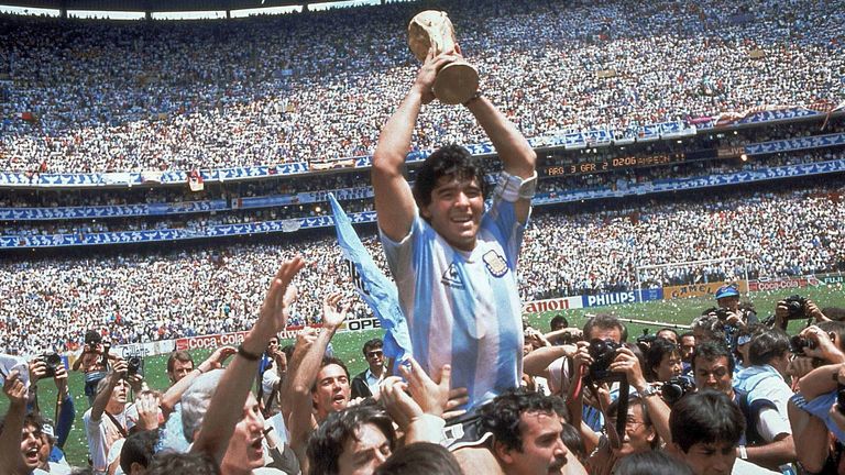 FILE - In this June 29, 1986 file photo, Diego Maradona holds up his team's trophy after Argentina's 3-2 victory over West Germany at the World Cup final soccer match at Azteca Stadium in Mexico City. 