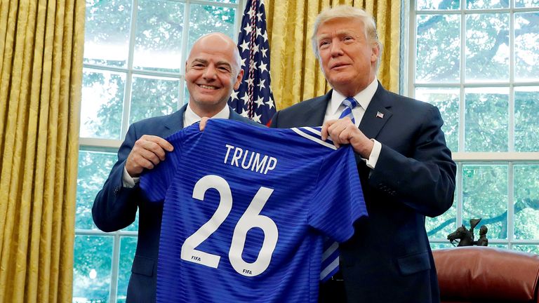 U.S. President Donald Trump poses with the President of FIFA Gianni Infantino with a gift jersey from Infantino in the Oval Office at the White House in Washington, D.C., U.S. August 28, 2018. REUTERS/Leah Millis