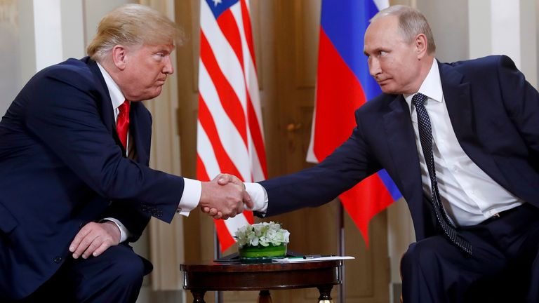 FILE - President Donald Trump, left, and Russian President Vladimir Putin shake hands at the beginning of a meeting at the Presidential Palace in Helsinki, Finland, July 16, 2018. (AP Photo/Pablo Martinez Monsivais, File)