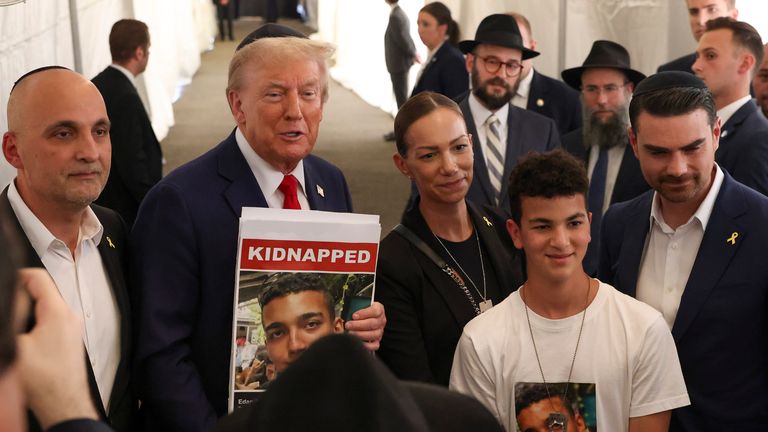 Donald Trump posed last year with family members of Edan Alexander in New York. Lying Photo: AP