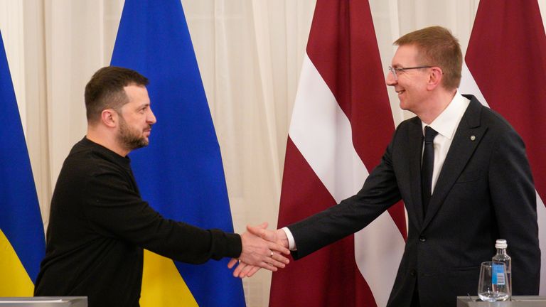 Latvia's President Edgars Rinkevics, right, and Ukrainian President Volodymyr Zelenskyy shake hands after their joint news conference in Riga, Latvia, Thursday, Jan.11, 2024. (AP Photo/Roman Koksarov)