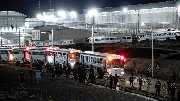 Salvadoran police officers escort alleged members of the Venezuelan gang Tren de Aragua t to be imprisoned in the Terrorism Confinement Centre.  Pic: Secretaria de Prensa de la Presidencia/