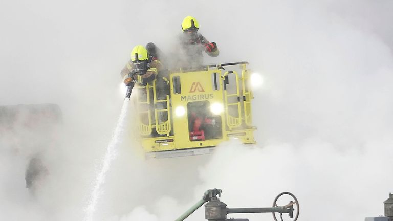 Firefighters extinguish the fire at the North Hyde electrical substation, which caught fire Thursday night and lead to a closure of Heathrow Airport in London, Friday, March 21, 2025.(AP Photo/Kirsty Wigglesworth)