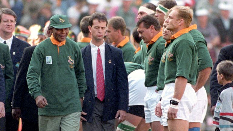 Nelson Mandela walks past Francois Pienaar in the line up before the Rugby World Cup Final in Johannesburg's Ellis Park. 
Pic: PA