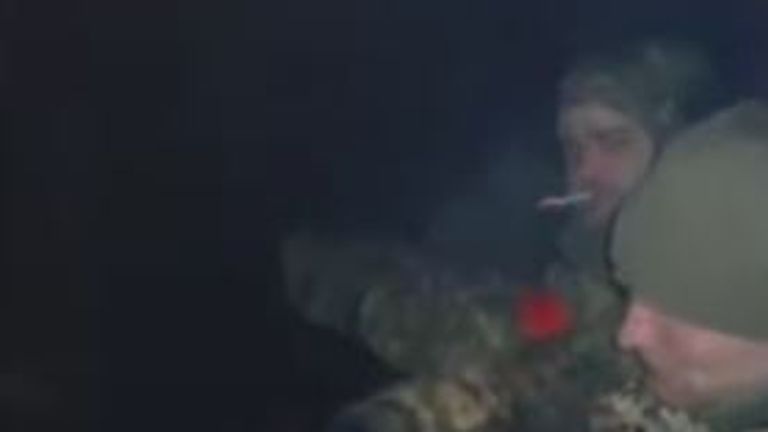 Soldiers are seen smoking cigarettes in the pipeline