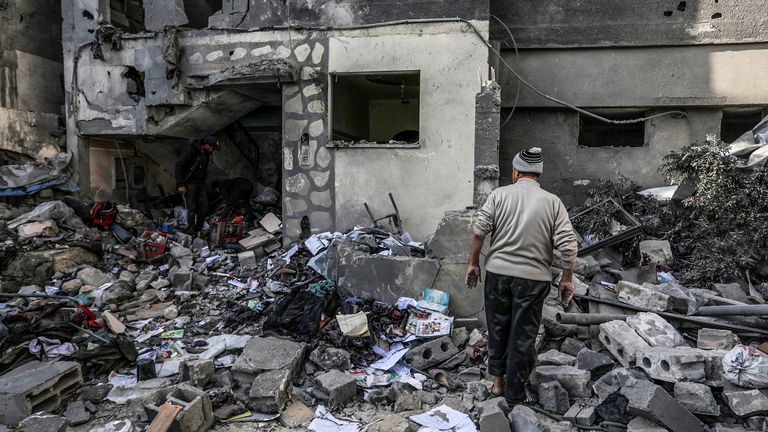 Palestinians search for their belongings among the rubble of their destroyed homes, following Israeli airstrikes on Khan Yunis. Pic: AP