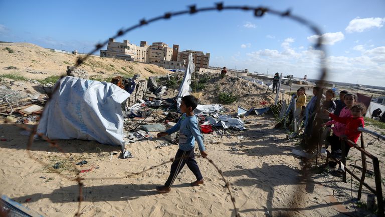 Palestinian children gather at the site of an Israeli strike on a tent housing displaced people, in Khan Younis, in the southern Gaza Strip.  Pic: Reuters