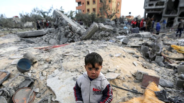 A child looks on as Palestinians inspect the site of an Israeli strike on a house, in Khan Younis.
Pic: Reuters