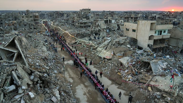 The Palestinians gather among the rubble for Iftar, the quick meal, the first day of Ramadan in Rafah, south of the enclave. Pic: AP / Abdel Kareem Hana