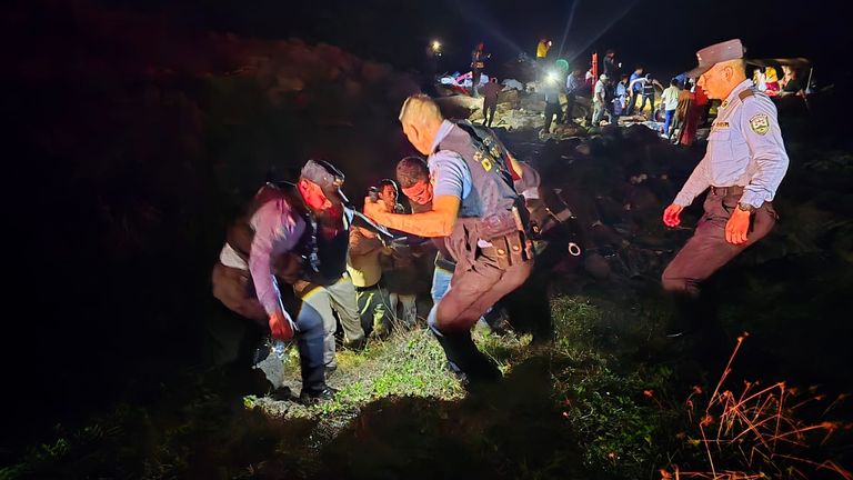 Adverse conditions were said to have hindered search efforts. Here emergency services carry a stretcher across the coast.Pic: Honduras National Police