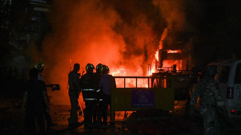 Vehicles burn after the clashes. Pic: Reuters