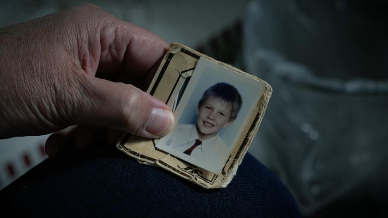 Andy's mother holds a picture of him as a child