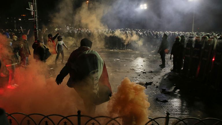 Riot police officers clash with protesters during a protest after Istanbul's Mayor Ekrem Imamoglu was arrested and sent to prison, in Istanbul, Turkey, Sunday, March 23, 2025. (AP Photo/Huseyin Aldemir)