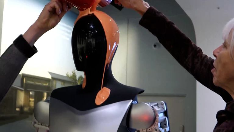 Two Just Stop Oil activists poured orange liquid latex on top of Elon Musk&#39;s  Tesla Optimus robot at a store in London.