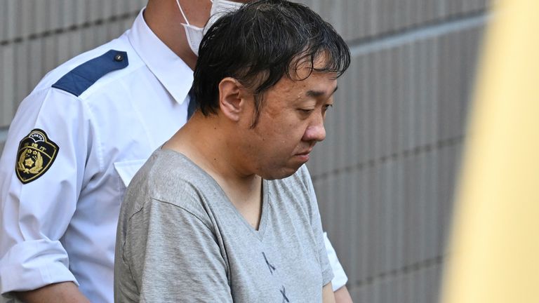 Kenichi Takano on his way to the prosecutors officer following his arrest. Pic: AP