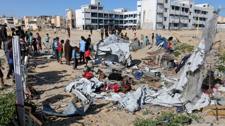 Palestinians inspect the site of an Israeli strike on a tent housing displaced people, in Khan Younis.
Pic: Reuters