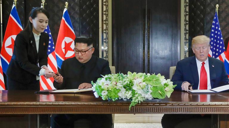 Hold for use with Story Slugged North Korea Kim ... s sister of Hyung -Jin Kim, file - in June 12, 2018, the file photo, the head of North Korea Kim Jong Un, the center left and the American president Donald Trump, center on the right, prepare to sign a document at the Capella Resort on Sentosa Island. At the last minute, Kim's sister, Kim Yo-Jong, on the far left, provided her own pen to her use. (AP photo / Evan Vucci, file)