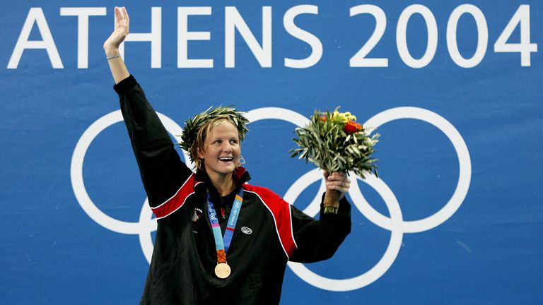 Kirsty Coventry from Zimbabwe celebrates after receiving her gold medal for the women's 200 metres backstroke at the Olympic Aquatics Center in Athens August 20, 2004 during the Athens 2004 Olympic Games swimming competition. Coventry won the gold medal for women's 200 metres backstroke on Friday in two minutes 09.19 seconds. REUTERS/Jerry Lampen AW/DL