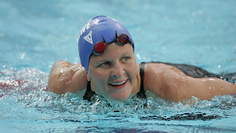 Zimbabwe's gold medallist Kirsty Coventry smiles at the women's 200 metres backstroke final at the Olympic Aquatics Centre in Athens, August 20, 2004. Coventry won the gold medal with a time of two minutes 09.19 seconds. REUTERS/Yves Herman CVI/DL