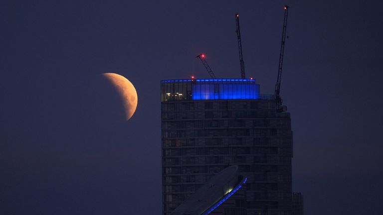 A lunar eclipse is visible above Canary Wharf in London as the full moon passes into Earth's shadow. Unlike in other parts of the world, except for some extreme western areas of the UK, the eclipse will be almost entirely partial. A lunar eclipse occurs when the Earth, sun, and moon are almost exactly in line and the moon is on the opposite side of the Earth from the sun. Picture date: Friday March 14, 2025. PA Photo. According to the Royal Astronomical Society, some people living in the west of the UK may see a total lunar eclipse with the naked eye - weather permitting. Others in the east and south east of England are only expected to be able to see a partial lunar eclipse. This is because the Moon won't be completely within the Earth's shadow by the time it sets. See PA story WEATHER Eclipse. Photo credit should read: Yui Mok/PA Wire