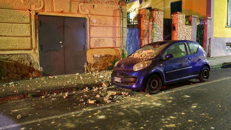 A damaged car is seen in the street after an overnight earthquake jolted Naples, Italy March 13, 2025. The quake struck at 01:25 local time (00:25 GMT), registering a magnitude of 4.4 according to Italy's National Institute of Geophysics and Volcanology (INGV). REUTERS/Ciro De Luca