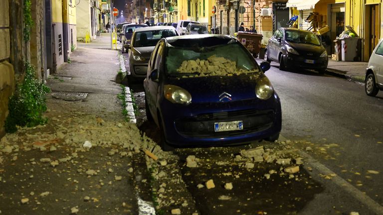 A damaged car is seen in the street after an overnight earthquake jolted Naples, Italy March 13, 2025. The quake struck at 01:25 local time (00:25 GMT), registering a magnitude of 4.4 according to Italy's National Institute of Geophysics and Volcanology (INGV). REUTERS/Ciro De Luca