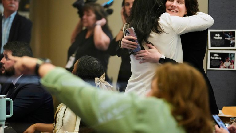 NASA employees react on Tuesday, March 18, 2025, at Johnson Space Center in Houston after watching astronauts splash down off the coast of Florida. (AP Photo/Ashley Landis)