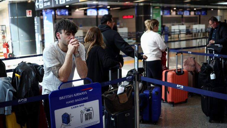 Nicolas Di Francescantonio waits for information about his flight to Heathrow International Airport at Fiumicino Airport in Rome, Italy