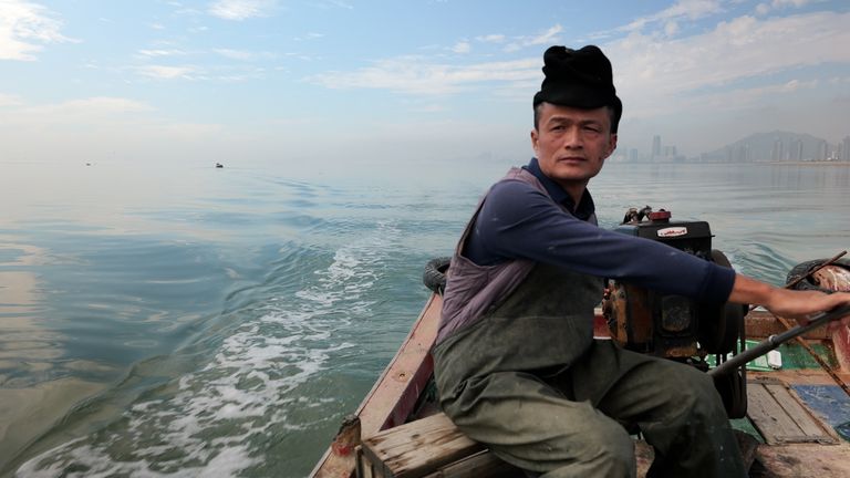 MAN ON FISHING BOAT AT SEA