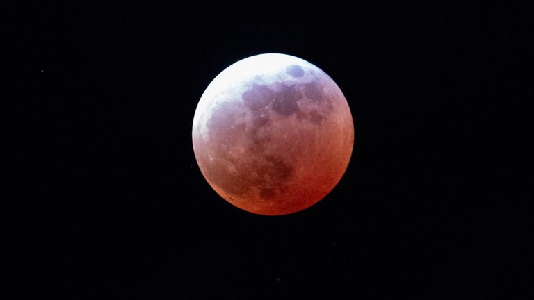 A total lunar eclipse enters its peak stage Thursday, March 13, 2025, in Portland, Ore. (AP Photo/Jenny Kane)