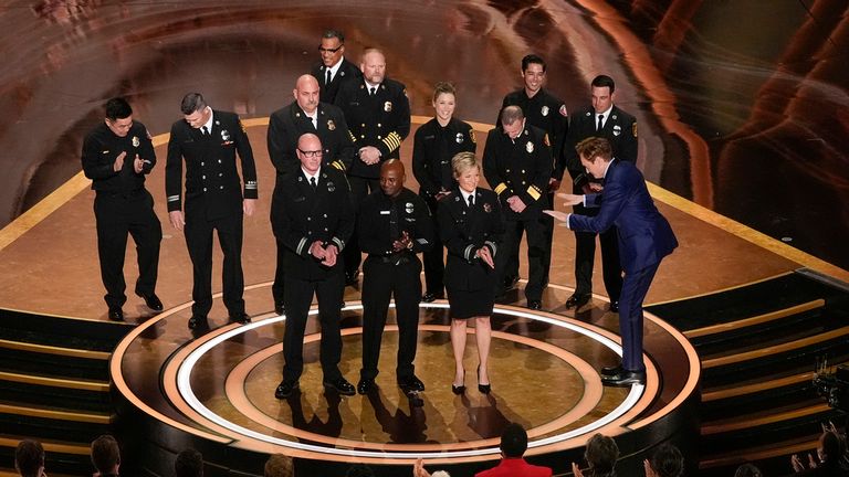 Members of the Los Angeles County Fire Department and Host Conan O'Brien, far right, on stage during the Oscars on Sunday, March 2, 2025, at the Dolby Theatre in Los Angeles. (AP Photo/Chris Pizzello)