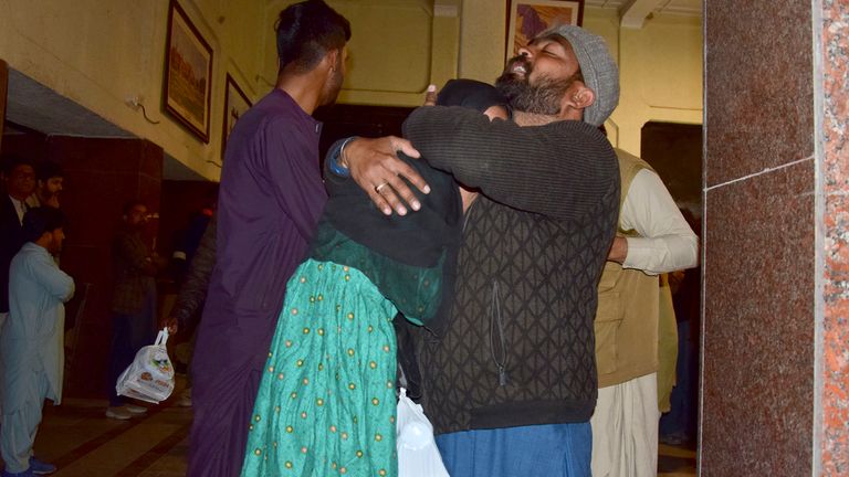 Passengers rescued by security forces from a passenger train attacked by insurgents comfort each other upon their arrival at a railway station in Quetta, Pakistan, Wednesday, March 12, 2025. (AP Photo/Arshad Butt)