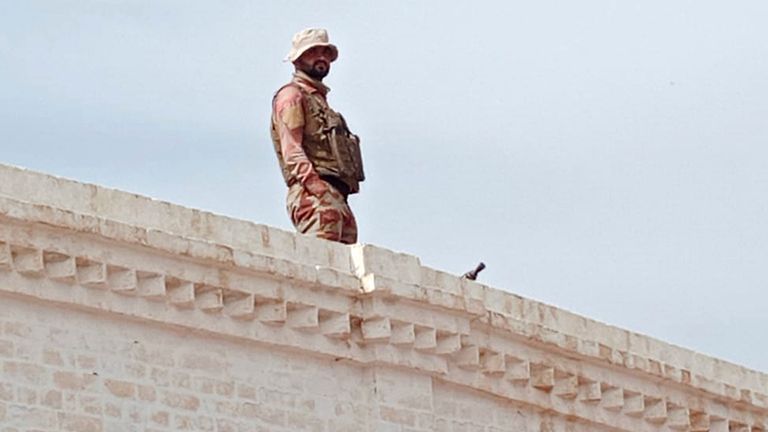 A paramilitary soldier takes position at a railway station near the attack site of a passenger train by insurgents, in Mushkaf in Bolan district of Pakistan's southwestern Balochistan province, Wednesday, March 12, 2025. (AP Photo)