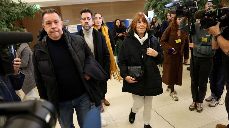 Gisele Pelicot, the victim of an alleged mass rape orchestrated by her husband Dominique Pelicot at their home in the southern French town of Mazan, is surrounded by journalists as she leaves with her sons David and Florian during the trial of Dominique Pelicot with 50 co-accused, at the courthouse in Avignon, France, November 18, 2024. REUTERS/Manon Cruz