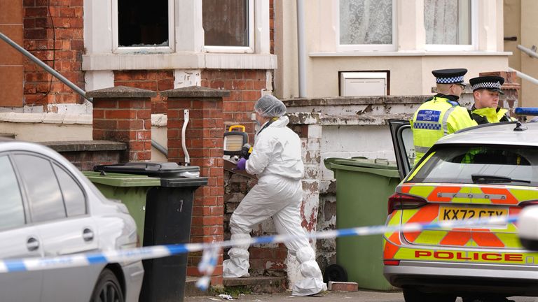 Forensic officers outside the house.  Pic: PA