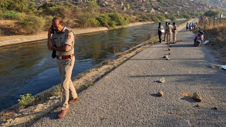 Police at the scene after male travellers were pushed into a canal by three men. Pic: AP