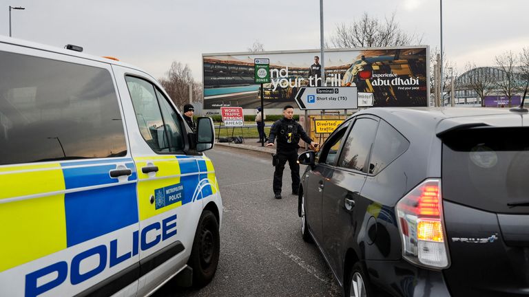 Police direct traffic outside Terminal 5 at the Heathrow International Airport.
Pic: Reuters