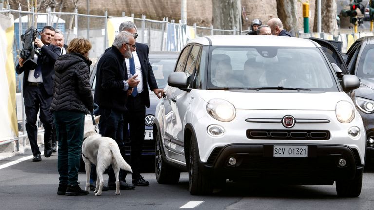 The Pope stops to greet dog walkers as he returns home to the Vatican. Pic: Reuters