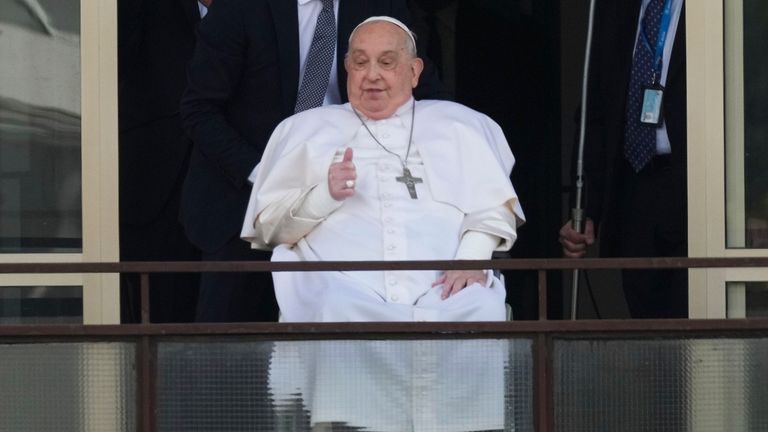 Pope Francis appears at a window of the Agostino Gemelli Polyclinic in Rome, Sunday, March 23, 2025, where he has been treated for bronchitis and bilateral pneumonia since Feb. 14. (AP Photo/Andrew Medichini)