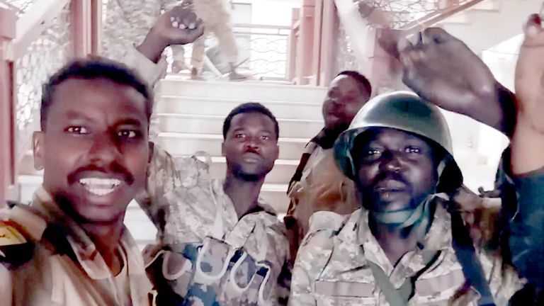 Sudanese army members film themselves inside the presidential palace.  Pic: Reuters  