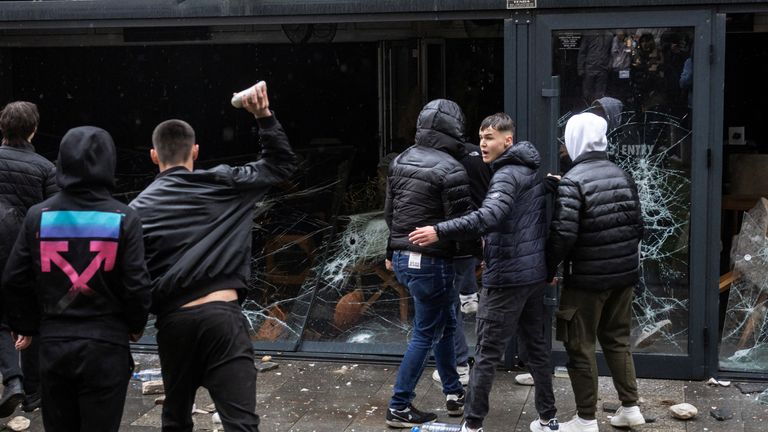 People smash a pub, which according to protesters belongs to the owner of Pulse nightclub.  Pic: Reuters