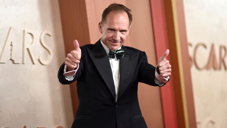 Ralph Fiennes clearly feeling good as he double thumbs up the cameras. Pic: AP