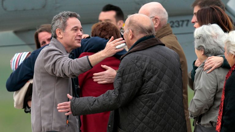 Released French hostage Didier Francois, left, is welcomed by his family upon arrival at the Villacoublay military airbase, outside Paris, Sunday April 20, 2014. Francois and three other French journalists kidnapped and held for 10 months in Syria returned home on Sunday to joyful families awaiting them. The four were freed by their captives a day earlier at the Turkish border. (AP Photo/Jacques Brinon)