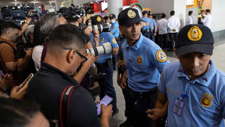 Police and media at the airport. Pic: Reuters