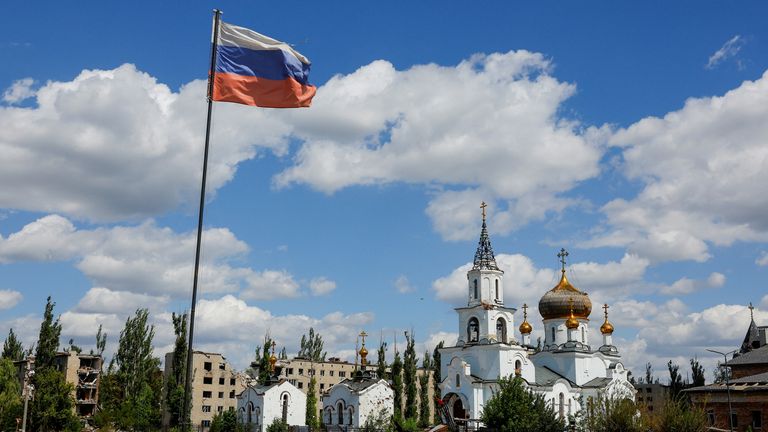 A Russian flag flies in the occupied town of Avdiivka, Donetsk. Pic: Reuters