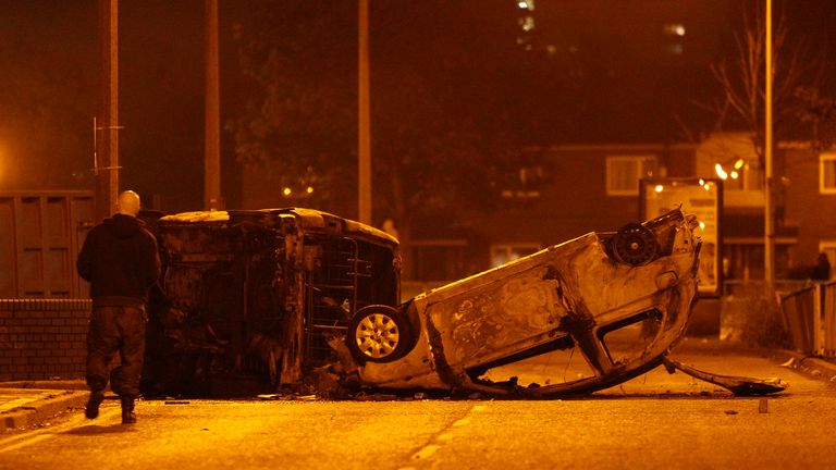 Burned cars lie on streets following rioting in Salford, near Manchester, in 2011. Pic: AP