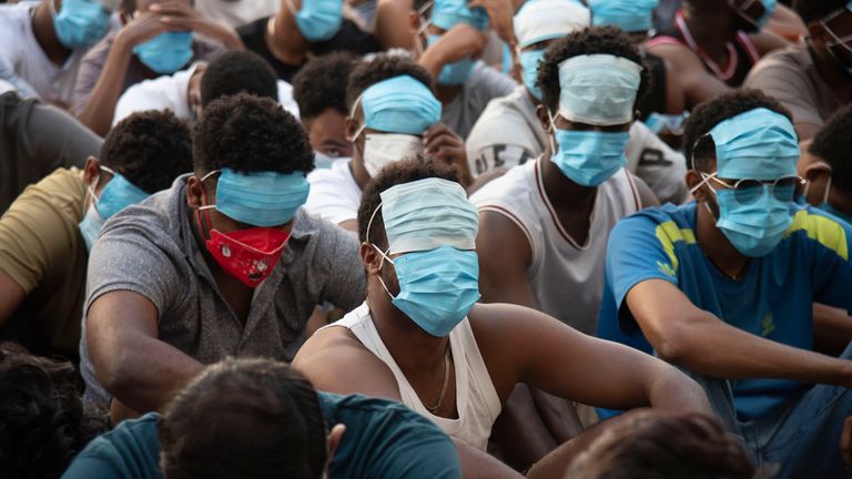 People believed to be former scammers sit in detention. Pic: Thanaphon Wuttison/AP