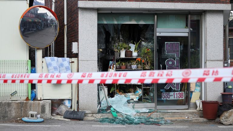 A shop with smashed windows. Pic: Reuters