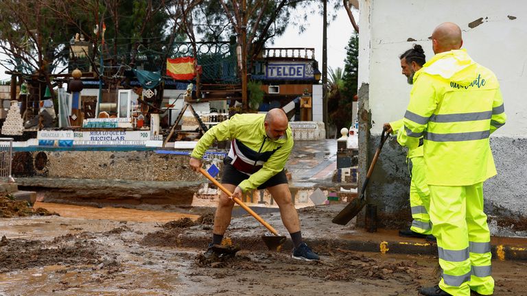 People clean the mud from the road washed away by the rain in the Ojos De Garza neighborhood in Telde, on the island of Gran Canaria, Spain.
Pic: Reuters